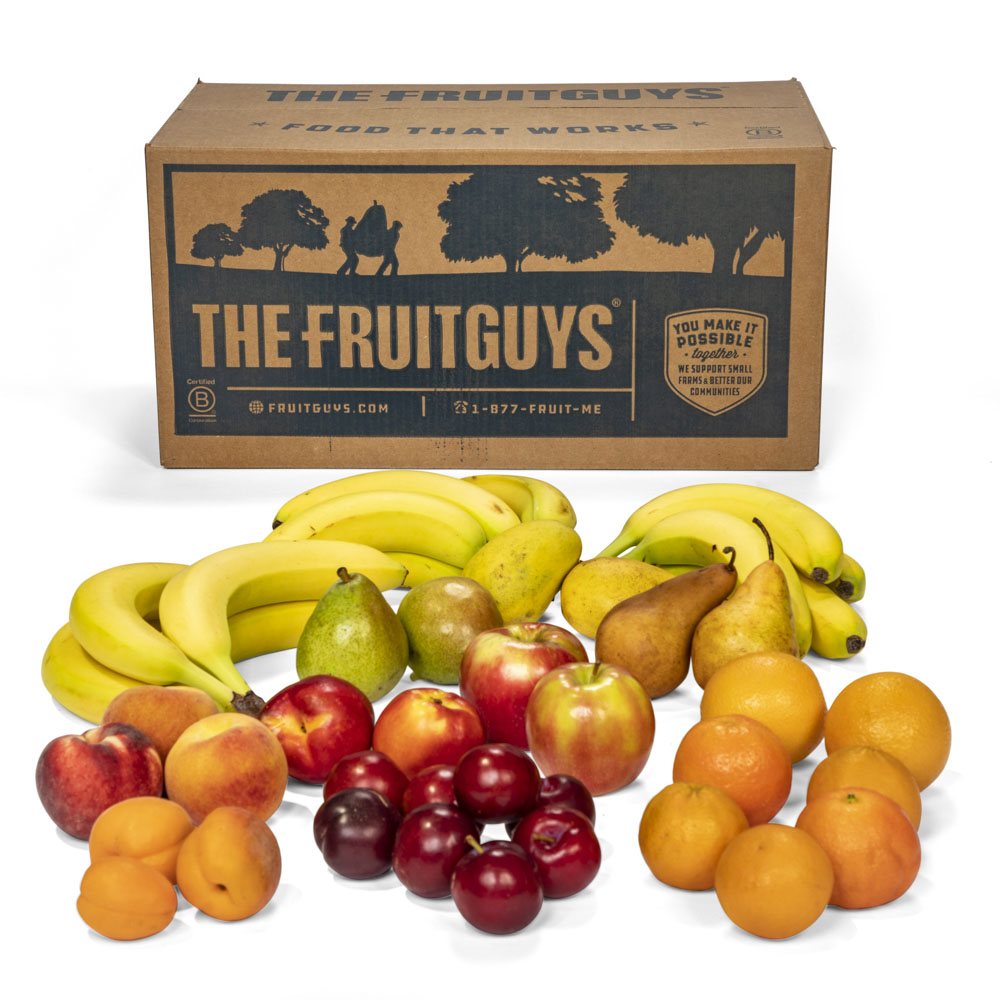The FruitGuys box surrounded by a variety of fruit