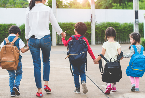 Woman walking with young students