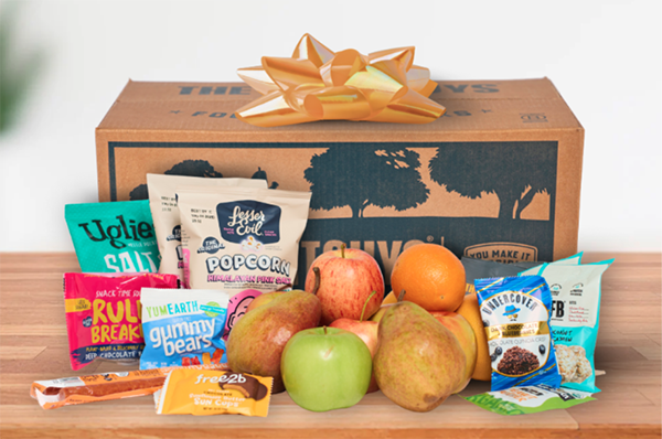 The FruitGuys box with a bow, fruit and snacks around it