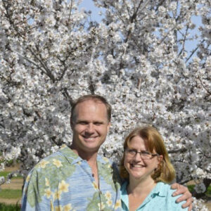 Smiling couple in front of a flowering tree