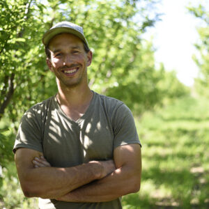 Smiling farmer in the orchard
