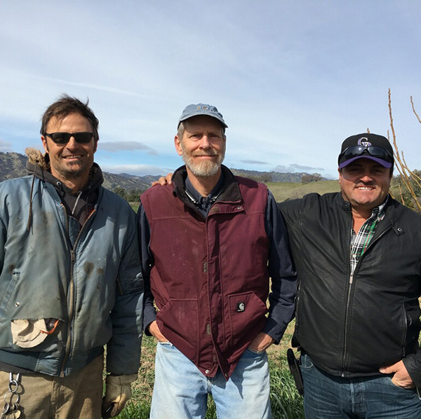 Smiling farmers on their far